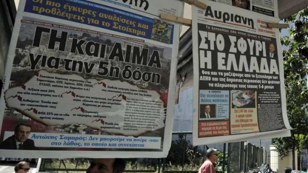 Disagreement over austerity measures ... newspaper headlines in Athens on Tuesday read ‘‘Greece for sale’’ and ‘‘Land and blood for fifth loan instalment’’.