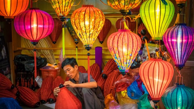 A man makes silk lanterns in his workshop, Hoi An, Vietnam.