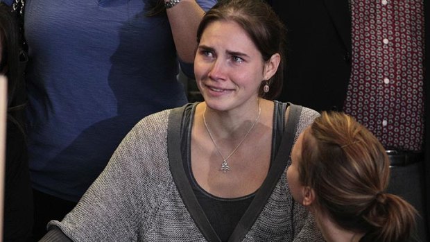 Support ... Amanda Knox is surrounded by family members shortly after her arrival at Seattle-Tacoma International Airport.