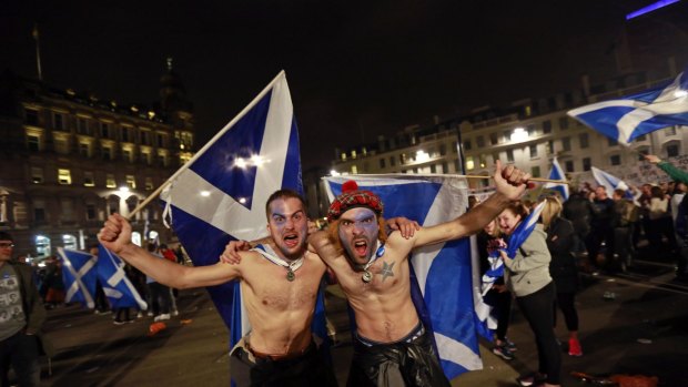 Supporters from the "Yes" Campaign wave Scottish  flags in central Glasgow on the night of the September referendum.