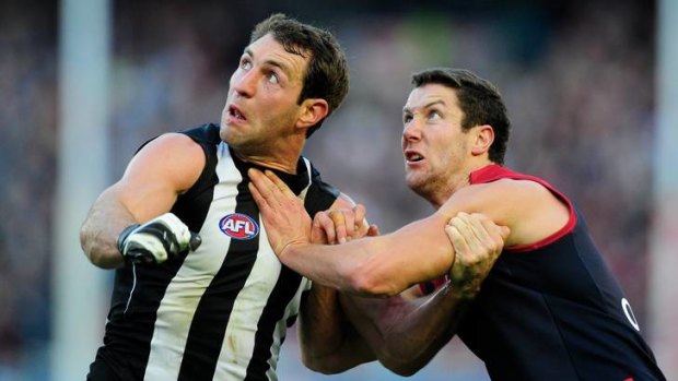 A tough tussle: Collingwood's Travis Cloke battles Melbourne's James Frawley during the Queen's Birthday clash.