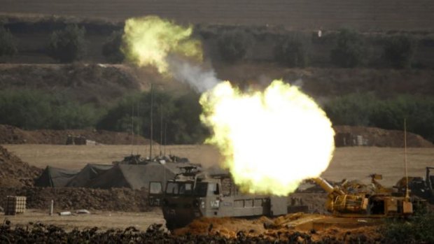 An Israeli artillery gun fires a 155mm shell towards targets from their position near Israel's border.