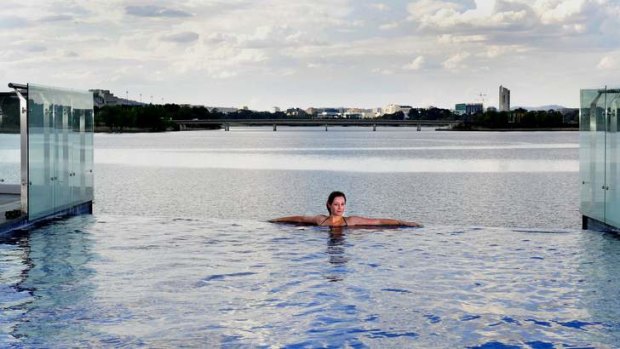 Catriona Rafael enjoys a dip in the infinity edge pool at the Lakefront Kingston Island apartment.