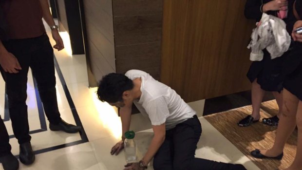 An injured man lies on the floor after gunmen attacked Resorts World Manila.