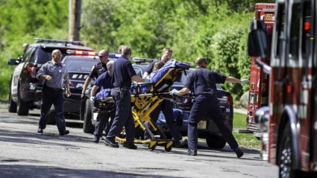 Determined to live: Rescue workers take the 12-year-old stabbing victim to an ambulance in Waukesha, Wisconsin on May 31.