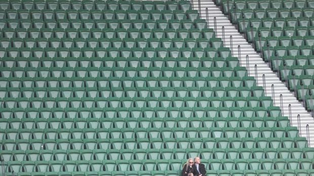 Uncrowded house: A small audience of 21,534 at the Melbourne versus Gold Coast match left two football fans with plenty of room to stretch out at the MCG yesterday.