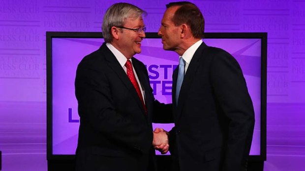 Kevin Rudd and Tony Abbott shake hands before last night's debate at the National Press Club in Canberra.