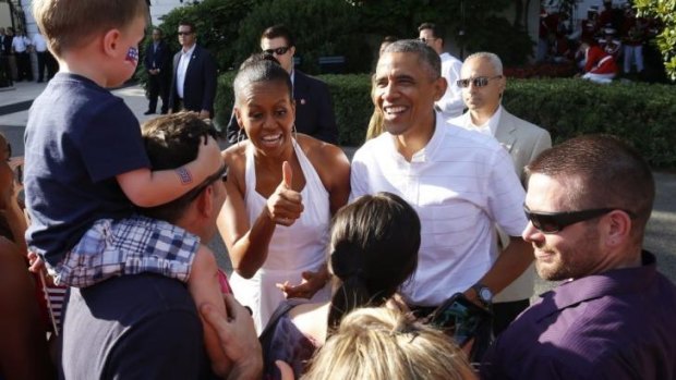 Happy Fourth of July: US President Barack Obama and First Lady Michelle Obama greet military families outside the White House.