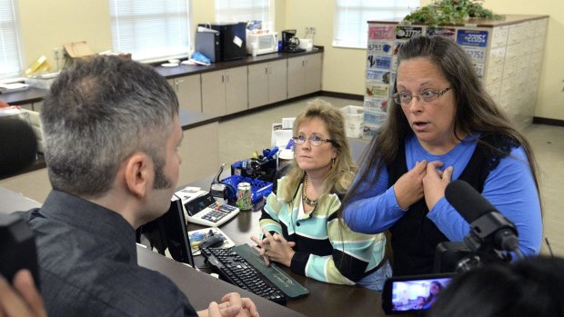 Rowan County Clerk Kim Davis, right, talks with David Moore, whose request for a marriage licence for him and David Ermold she had refused.