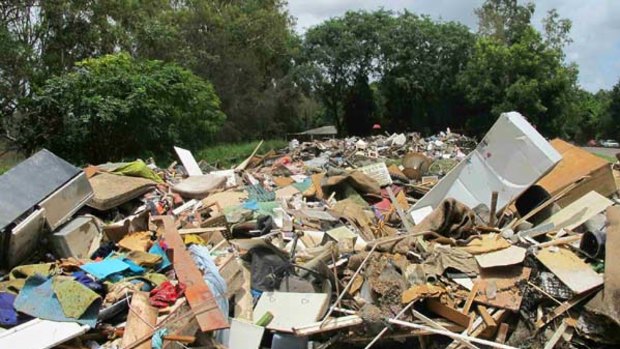 A temporary dumping site is set up at Lions Park on January 15 for the ruined possessions of Bellbowrie residents.