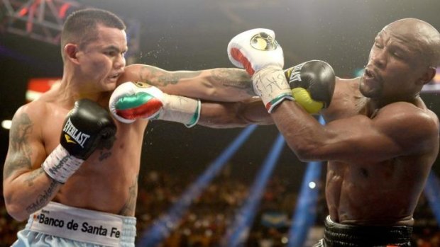 Toe to toe: Marcos Maidana and Mayweather Jr. exchange blows.