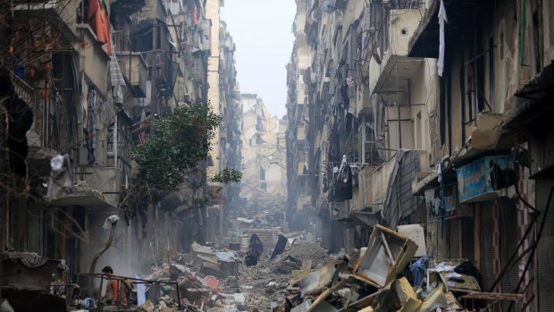 Residents walk through the destruction of the once rebel-held Salaheddine neighbourhood in eastern Aleppo, Syria. 