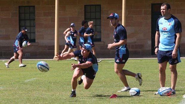 Hand up ... Brendan McKibbin fires out a pass at training with the Waratahs at Victoria Barracks.