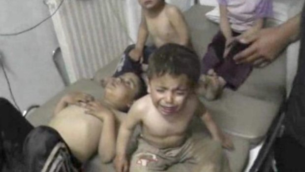 Innocent victim: A child cries after the poison gas attack in Kfar Zeita.