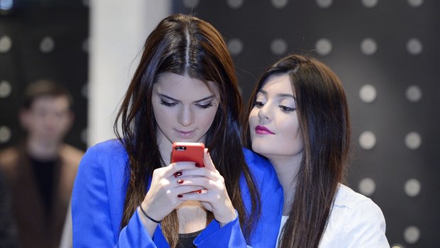You've been phubbed: television personalities Kendall Jenner (L) and Kylie Jenner. 