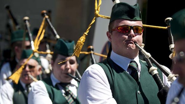 The Queensland Irish Association Pipe Band keeps the huge St Patrick's Day crowd tapping their toes.