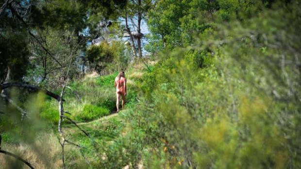 A man enjoys the warm weather at the Kambah Pool nudist area.