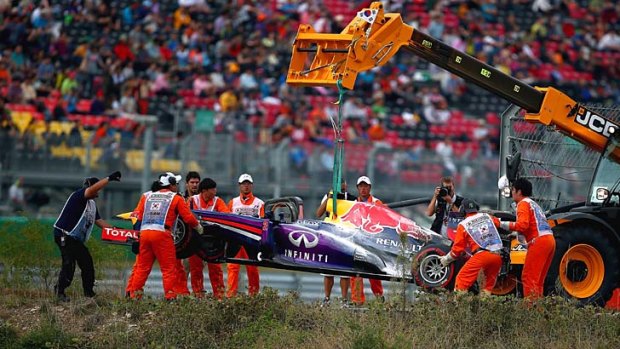 Mark Webber of Australia and Infiniti Red Bull Racing is lifted from the track after he retires early from the Korean Formula One Grand Prix.