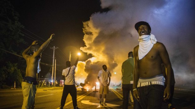 Demonstrators confront police during ongoing protests in reaction to the shooting of teenager Michael Brown.