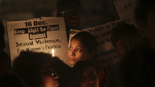 Indians students hold placards during a candle light vigil on anniversary of the fatal gang rape of a young woman in a bus New Delhi, India.