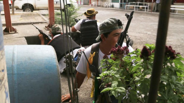Taking positions: Members of the citizens' self-help group arrive at Nueva Italia in Michoacan State, Mexico.