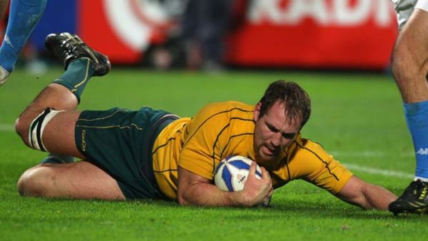 Wallaby captain, Rocky Elsom dives over for a try.