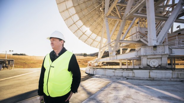 Canberra Deep Space Communication Complex spokesman Glen Nagle with one of the existing 34-metre antennas. 