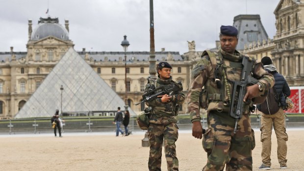 Soldiers patrol in the courtyard of the Louvre.