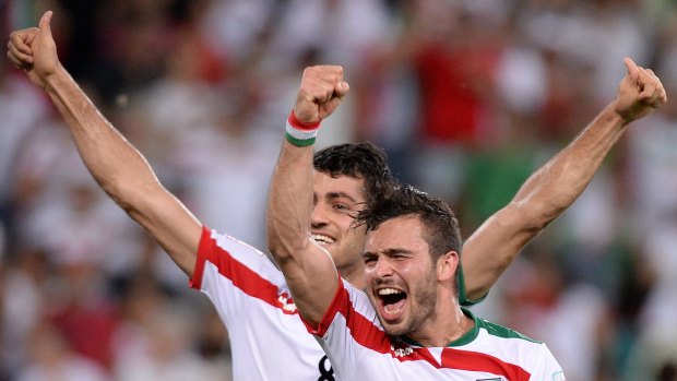Players warned against selfies with female fans ... Soroush Rafiei and Morteza Pouraliganji of Iran celebrate their team's victory over the UAE at Suncorp Stadium in Brisbane.