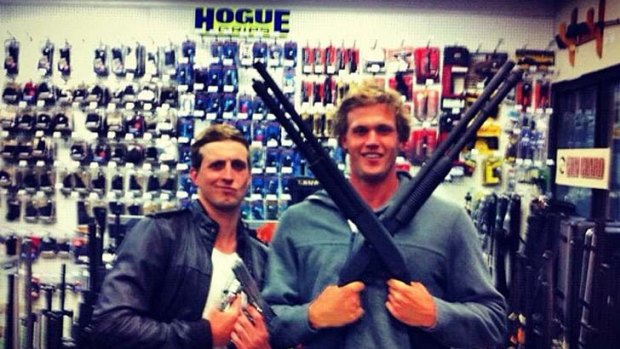 Australian swimmer Nick D'Arcy and team-mate Kenrick Monk posing with guns in a picture on D'Arcy's Facebook page.
