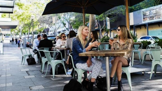 The reinvention of Double Bay: Edwina Miller and Ella Bunbell enjoy a glass of wine at a cafe. 