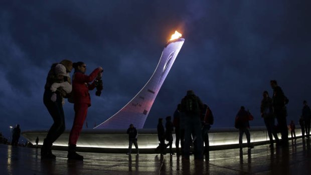 Fans pose for photos with the Olympic cauldron in the background. But what happens when the crowds melt away?