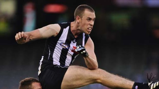It's crunch time: Sydney's Ben McGlynn tries to hold onto Collingwood's Nick Maxwell.
