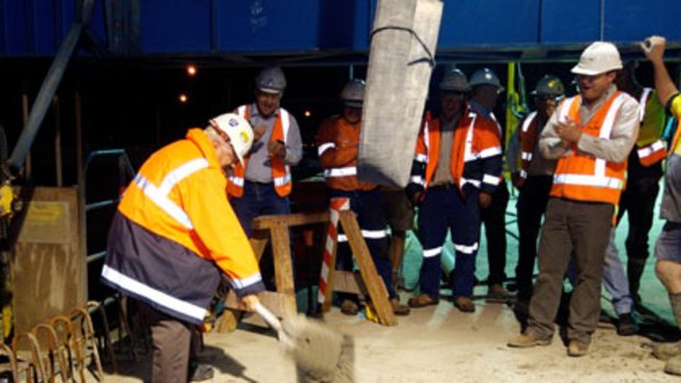 Peter Rotolone smooths the last of the concrete into place joining the second Gateway Bridge.