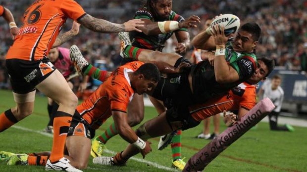 Tiger toughs: Souths centre Kirisome Auva'a is bundled into touch just short of the line.