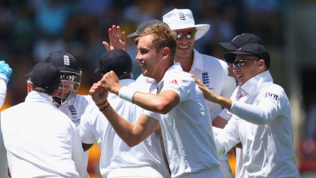 Stuart Broad celebrates with his team after taking the wicket of Michael Clarke.