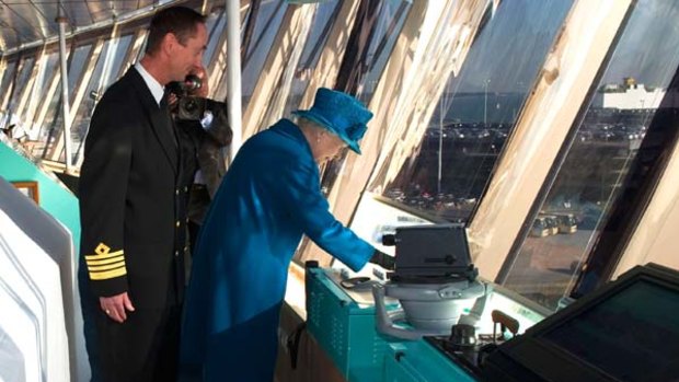 Britain's Queen Elizabeth sounds the ship's siren during her tour.