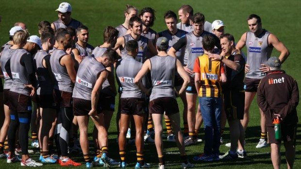 Alastair Clarkson introduces a fan to the players at Waverley Park on Friday.