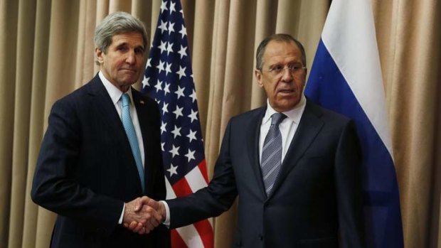 Done deal: US Secretary of State John Kerry shakes hands with Russian Foreign Minister Sergei Lavrov.
