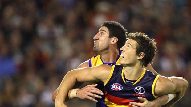 Tall order: Eagle Dean Cox and Adelaide's Kurt Tippett competing for the ball at AAMI Stadium.