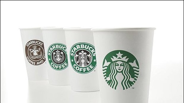 The new logo and, in the background, cups with earlier logos, from left: 1971, 1987 and 1992.