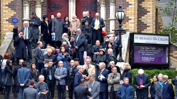 Crowds wait at St Michaels across Russell Street for the state funeral of former prime minister Malcolm Fraser at Scots' Church in Melbourne.