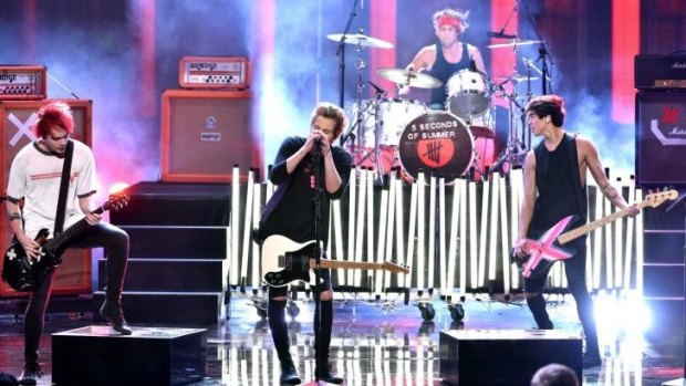 Nip slip: 5 Seconds of Summer's (from left) Michael Clifford, Luke Hemmings, Ashton Irwin and Calum Hood perform at the AMAs.