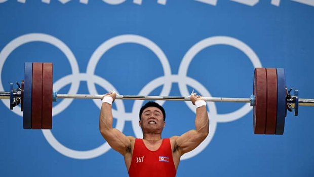 The showman delivers ... Kim Un Guk's winning lift.