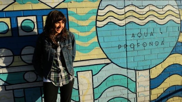 Courtney Barnett in front of the Aqua Profunda sign at the Fitzroy Pool.