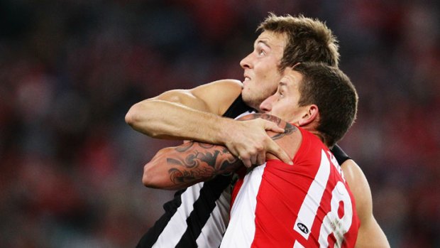 Scrap ... the Swans' Jesse White tussles with Magpie Ben Reid.
