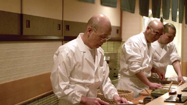 Roll model ... Jiro Ono, 87, prepares the food in the kitchen at his restaurant, Sukiyabashi Jiro.