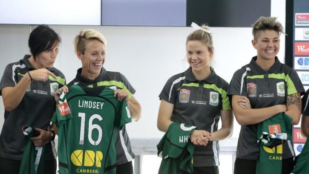 Canberra United players Holly Houston, left, hams it up next to Lori Lindsey, 2nd from left, during the Canberra United season launch at the University of Canberra. 