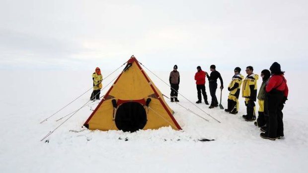 The survival training group learns how to erect a polar pyramid tent.