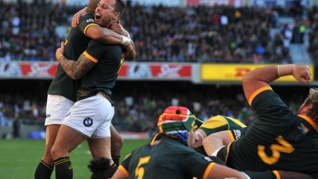 On a roll: The Springboks celebrate Marcell Coetzee's try.